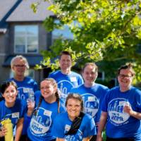 Nine Alumni standing together.